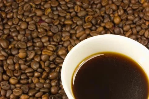 A cup of coffee with a coffe bean Stock Photos
