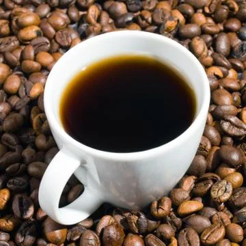 A cup of coffee with coffee bean as background Stock Photos
