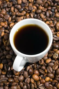 A cup of coffee with coffee bean as background Stock Photos