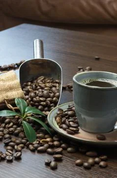 A cup of coffee with coffee bean as background Stock Photos