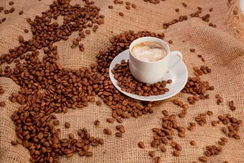 Cup of coffee on coffee beans background Stock Photos