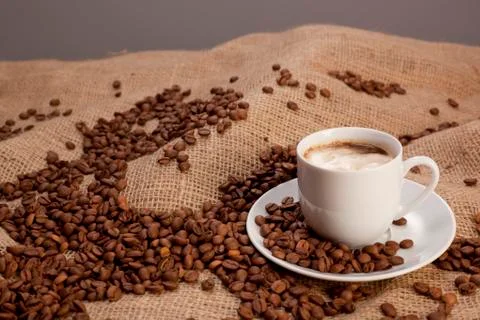 Cup of coffee on coffee beans background Stock Photos