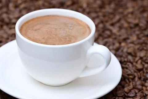 Cup of coffee on a coffee beans background Stock-Fotos