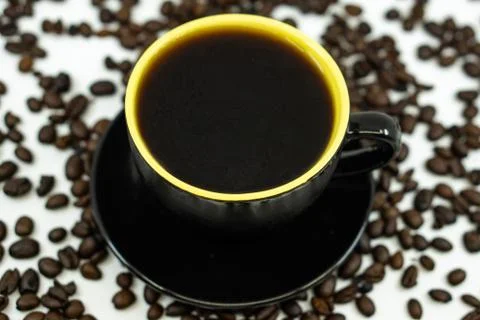 A cup of coffee on coffee beans background. Selective focus. Stock Photos