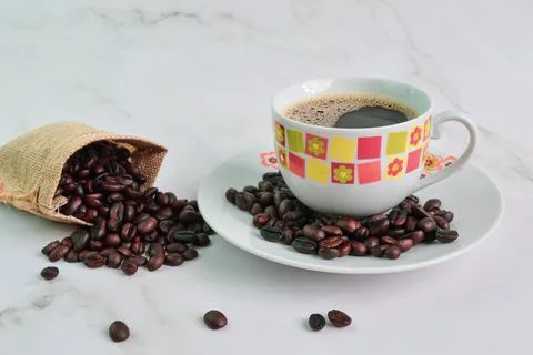 A cup of coffee with coffee beans isolated on a white background Stock Photos