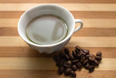 A cup of coffee, coffee beans Stock Photos