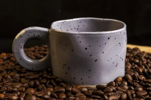A cup of coffee with coffee beans. Stock Photos