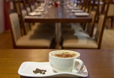A cup of coffee with coffee beans on the side Stock Photos