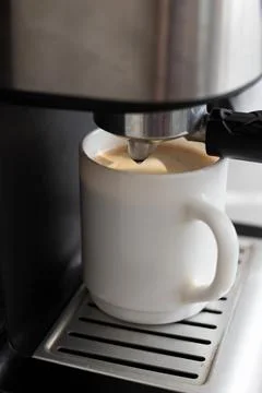 A cup of coffee in a coffee machine close-up Foto stock
