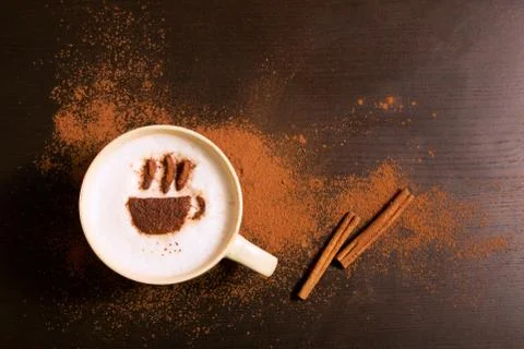Cup of coffee with coffee pattern of cinnamon Stock Photos
