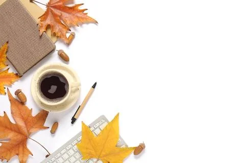 Cup of coffee with computer keyboard, notebooks, autumn leaves and acorns on  Stock Photos