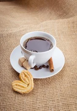 Cup of coffee, cookie on sackcloth background Stock Photos