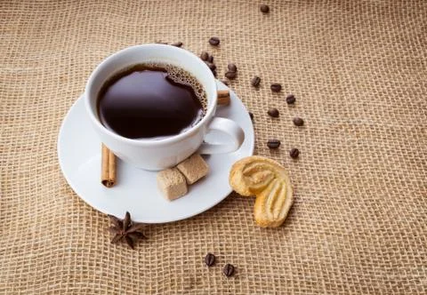 Cup of coffee, cookie on sackcloth background Stock Photos