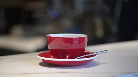 A cup of coffee in a cozy cafe with steam appearing Stock Footage 331224589