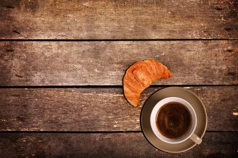 Cup of coffee with croissant Stock Photos