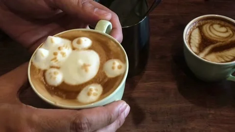 A cup of coffee with cute animal shape latte art, perfect for breakfast time. 動画素材 334650926