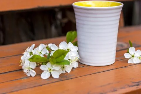 A cup of coffee on a dark, worn rustic wooden table. The composition is decor Stock Photos