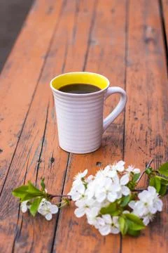 A cup of coffee on a dark, worn rustic wooden table. The composition is decor Stock Photos
