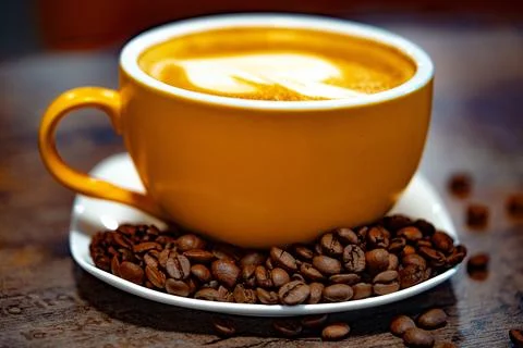Cup of coffee decorated with heart and coffee beans transparent dark background 스톡 사진