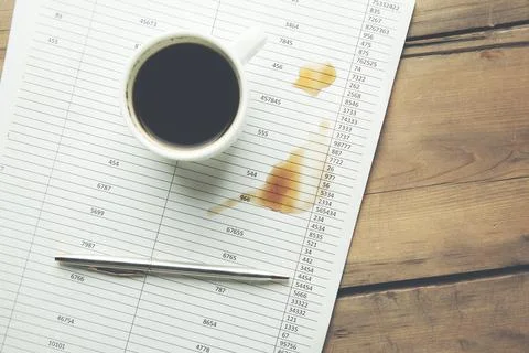 Cup of coffee on document Stock Photos