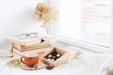 Cup coffee drink box various chocolates ceramic dish. Morning tea by the window Stock Photos