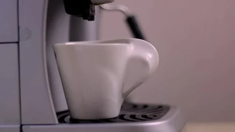 A cup of coffee is on the espresso machine Stock Footage 83129173