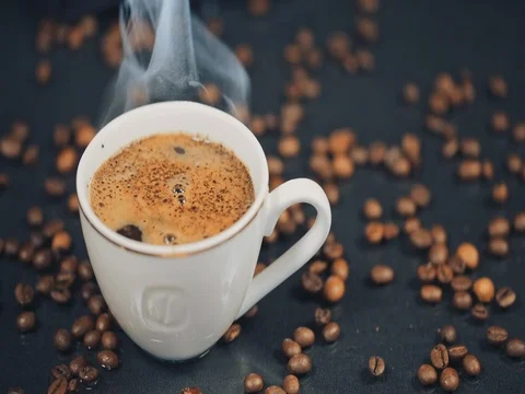 A Cup of Coffee. Falling grains of coffee on the table. Slow motion 스톡 동영상 73668389