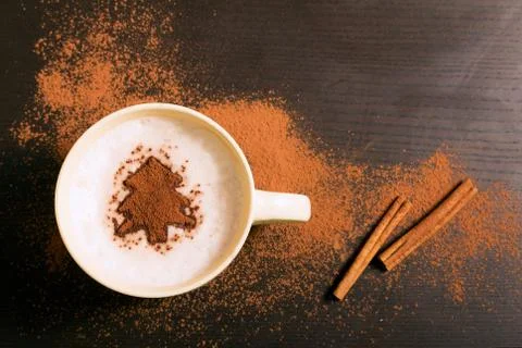 Cup of coffee with fir tree pattern of cinnamon Stock Photos