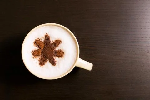 Cup of coffee with flower pattern of cinnamon Stock Photos