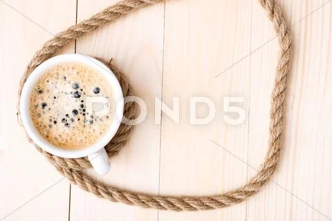 Cup of coffee with foam on wooden table Stock Photos
