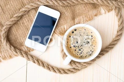 Cup of coffee with foam on wooden table Stock Photos