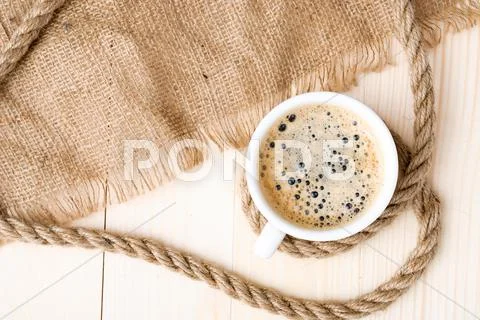 Cup of coffee with foam on wooden table Stock Photos