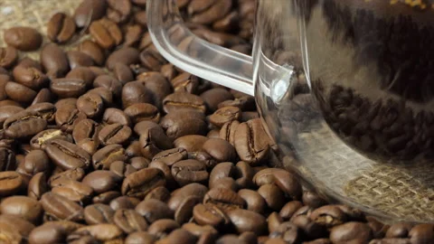 Cup of coffee with fresh roasted coffee beans background. A filled transparent Stock Footage 195310341