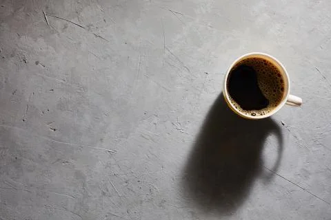 Cup of coffee on a gray background top view. Copyspace Stock Photos