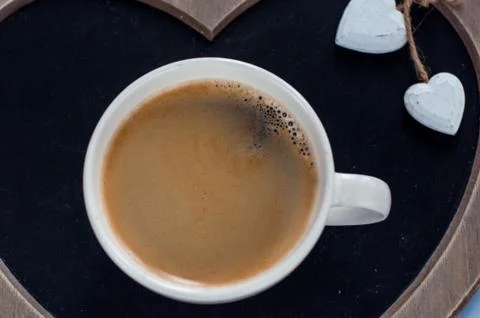 Cup of coffee on grey background, top view Foto stock