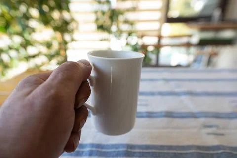 A cup of coffee at hand Stock Photos