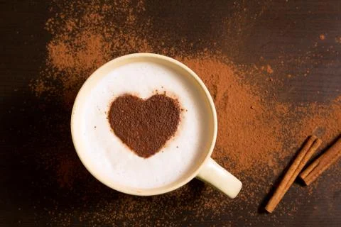 Cup of coffee with heart pattern of cinnamon Stock Photos