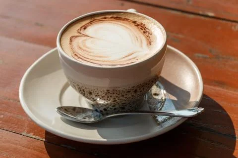 A cup of coffee with heart pattern Stock Photos