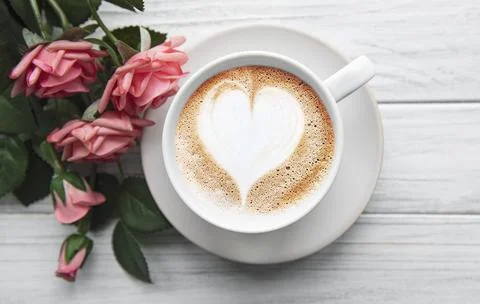 A cup of coffee with heart pattern Stock Photos