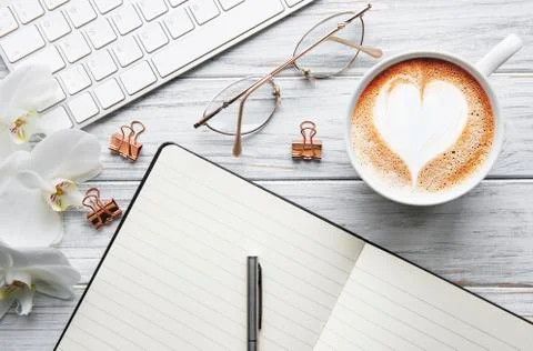 A cup of coffee with heart pattern on a table Stock Photos