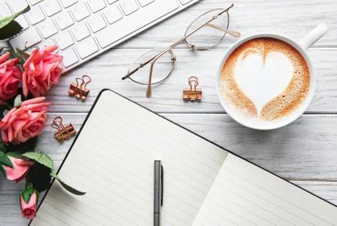 A cup of coffee with heart pattern on a table Stock Photos