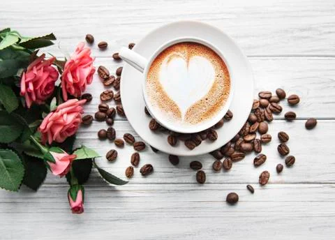 A cup of coffee with heart pattern on a table Stock Photos