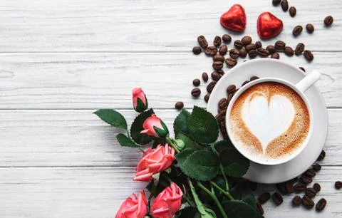 A cup of coffee with heart pattern on a table Stock Photos
