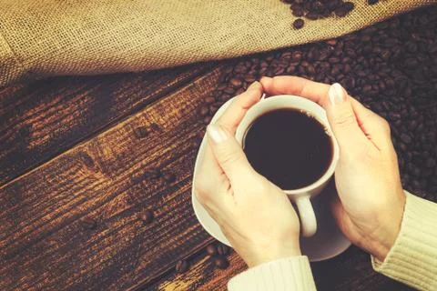 Cup of coffee in her hands Foto stock