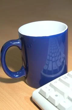 Cup of coffee with keyboard reflection on the Stock Photos
