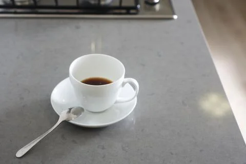 Cup of coffee on kitchen table Stock Photos