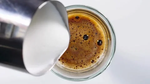 A cup of coffee with latte art, closeup top shot. Coffee beverage idea concept. 動画素材 334650520
