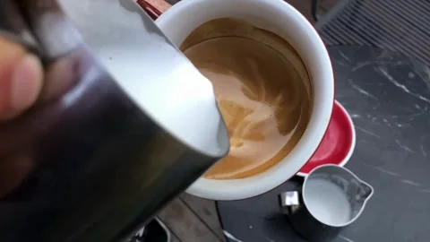 A cup of coffee with latte art, closeup top shot. Coffee beverage idea concept. 動画素材 334650541