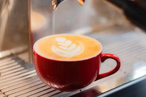 Cup of coffee latte on coffee maker Stock Photos