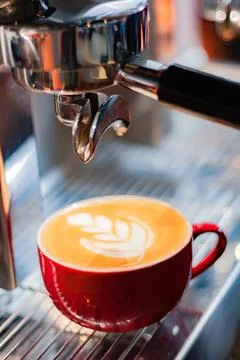 Cup of coffee latte on coffee maker Stock Photos